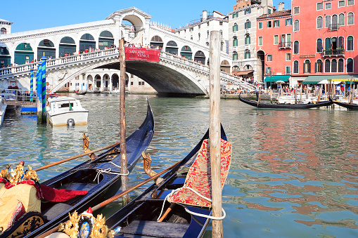 Venice. Italy - May 1, 2007: Gondolas moored in front of Rialto Bridge.