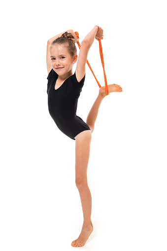girl athlete is engaged in gymnastics on a white background with copy space.