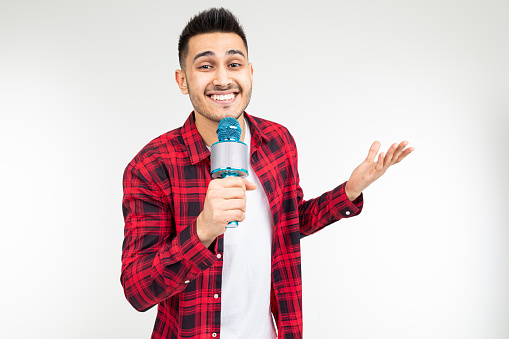performer guy singer in a shirt with a microphone in his hands on a white background.