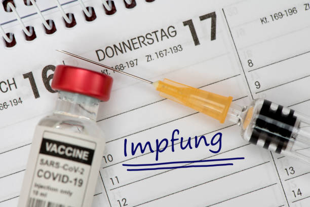 istock vaccination with serum and syringe against COVID-19 virus 1297228731