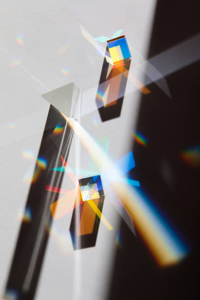 istock Glass geometric figures prisms with light diffraction of spectrum colors and complex reflection with trendy light and hard shadows on a white background 1297229551