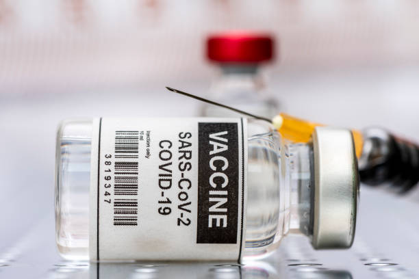 istock vaccination with serum and syringe against COVID-19 virus 1297230646