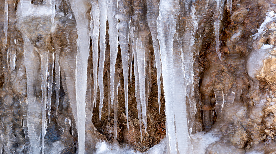 icicles formed after snowfall on rocks