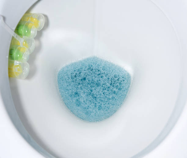 istock bottom of white toilet bowl with blue water and solid disinfectants 1297231058
