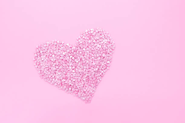 istock Pink background. Pink hearts on a pink background. Hearts sprinkles. 1297231788