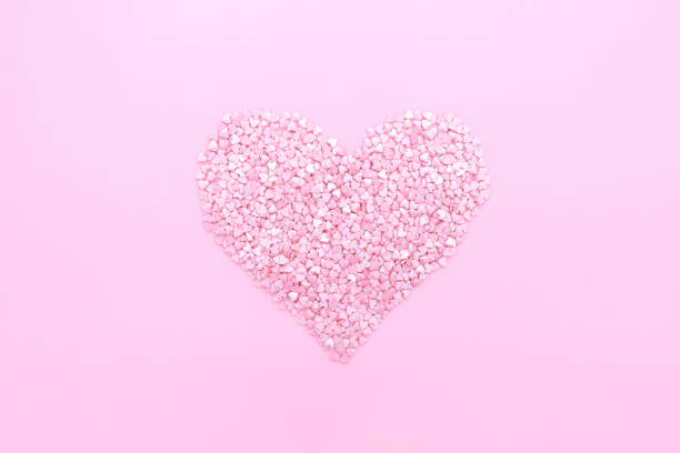 istock Pink background. Pink hearts on a pink background. Hearts sprinkles. 1297231792