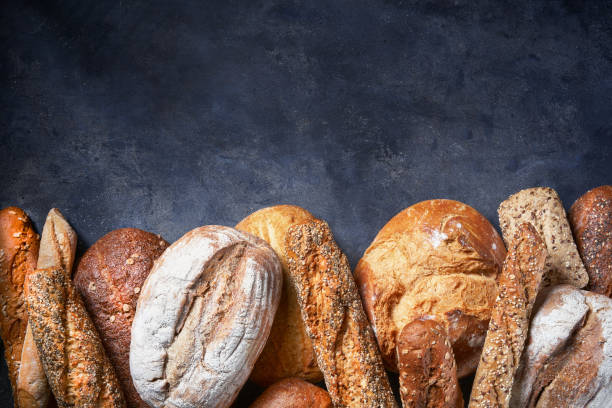 istock Background with Different Types of Bread on dark surface. Close up. Bakery concept. Empty space for text. 1297232072