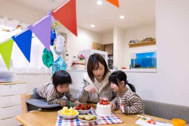 istock Young mother and two kids preparing for her son's first birthday 1297233777
