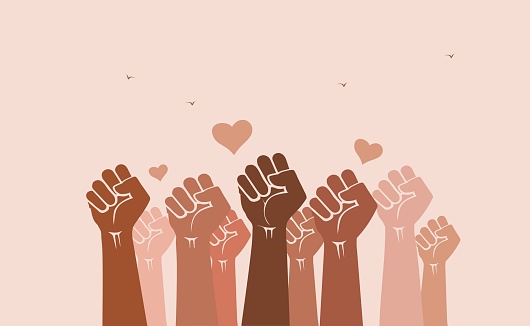 People's fists raised in the air with heart-shaped love symbols. Solidarity, unity, love, diversity and inclusion concept. Teamwork, racial harmony and tolerance.