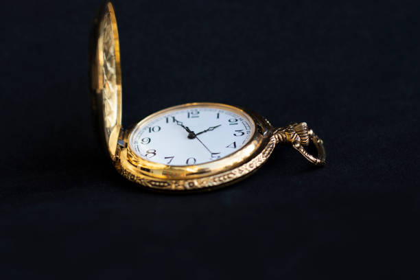 istock Antique gold pocket heritage watch is placed on black background 1297235621
