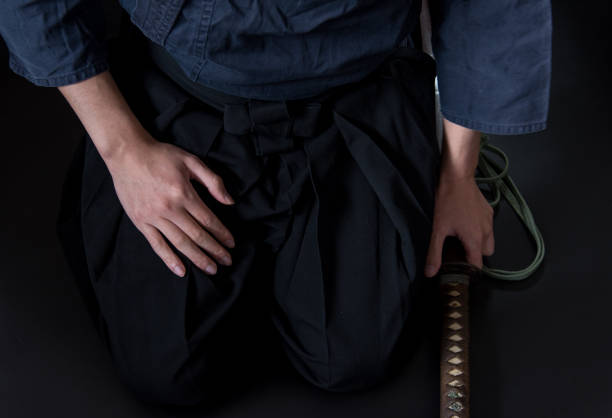 istock A seated man holding his sword with one hand. 1297235706