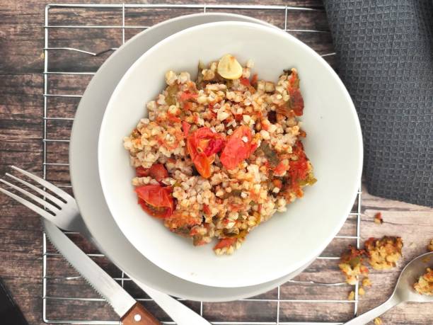 Buckwheat bowl A plate with a vegetarian buckwheat risotto Artichoke stock pictures, royalty-free photos & images