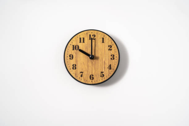 istock wood office wall clock with white dial on white background. wall clock on white background, top view. 1297236676