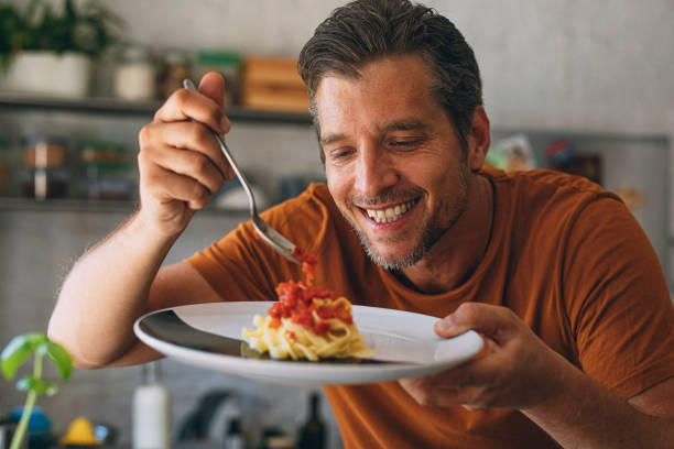 istock Handsome Young Caucasian Man Making Classic Tagliatelle in a Kitchen 1297236812