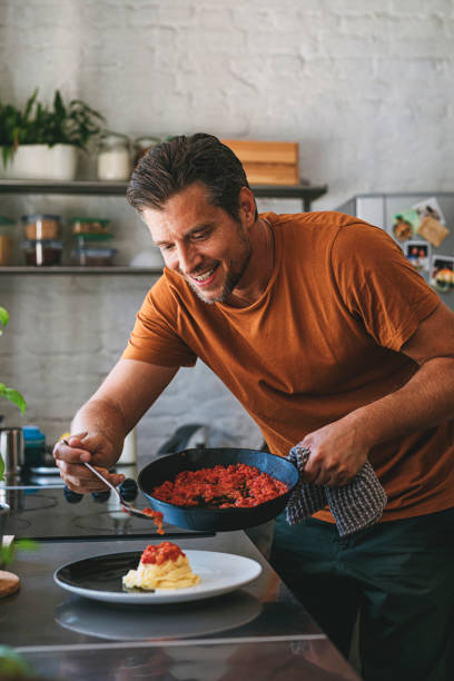 istock Handsome Young Caucasian Man Making Classic Tagliatelle in a Kitchen 1297236813