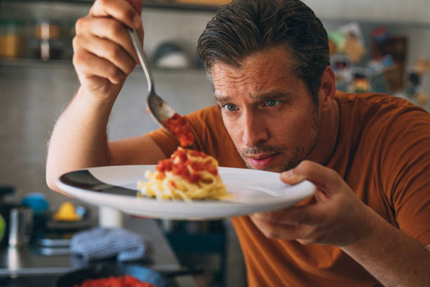 istock Handsome Young Caucasian Man Making Classic Tagliatelle in a Kitchen 1297236819