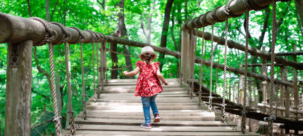 istock Girl playing in the forest park 1297237452
