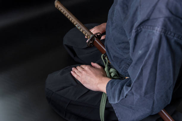 istock A seated man holding his sword with one hand. 1297238200