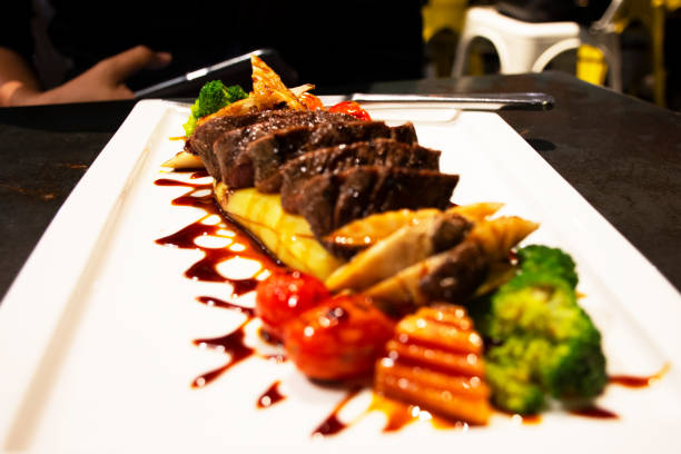 istock Medium rare beef steak topping gravy sauce put on mashed potatoes served with grilled vegetable salad 1297238259