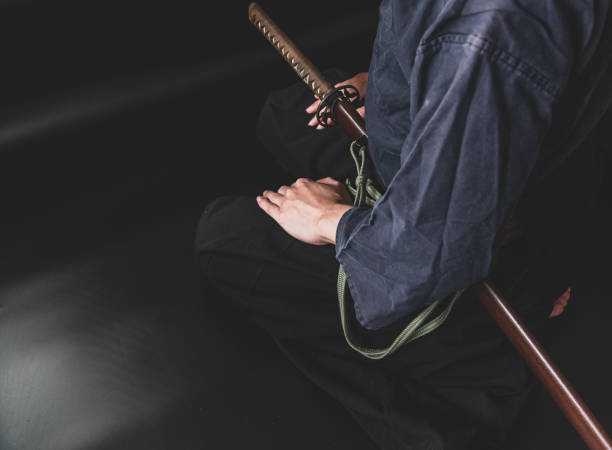 istock A seated man holding his sword with one hand. 1297238850