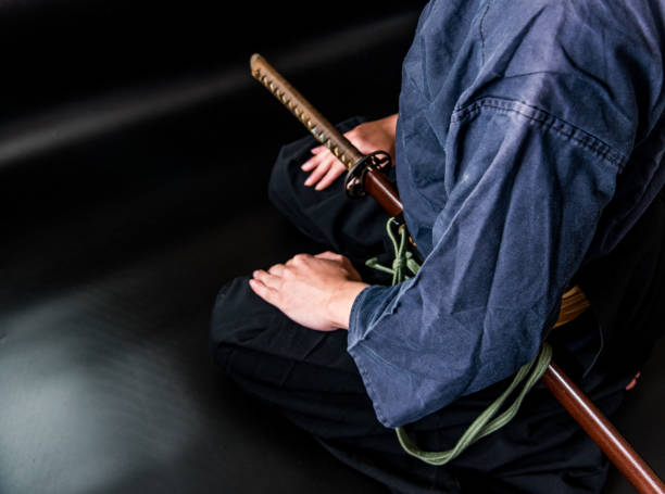 istock A seated man holding his sword with one hand. 1297239567