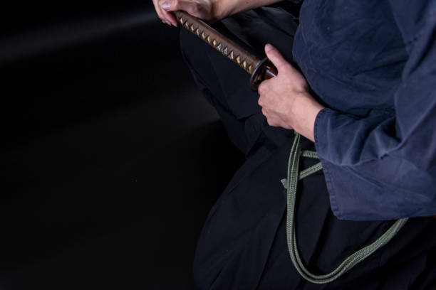 istock A seated man holding his sword with one hand. 1297239612