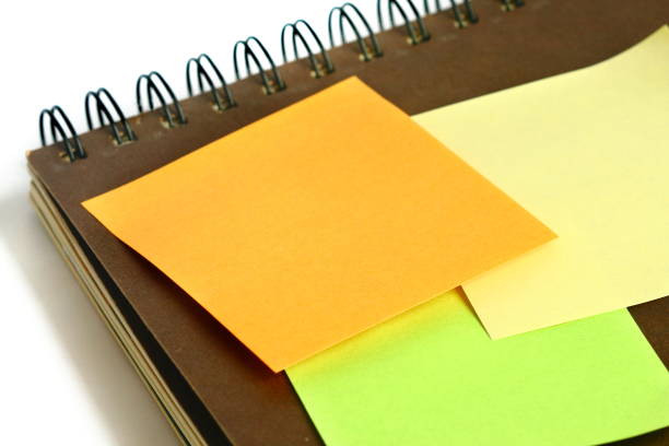istock colorful post it paste on brown notebook on white background have copy space for put text to do list 1297239630