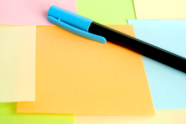 istock close up orange post it with colorful notes with pen have copy space for put text 1297239649