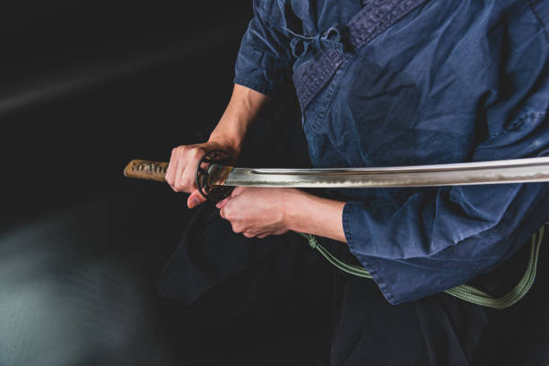 istock A seated man holding his sword with one hand. 1297240104