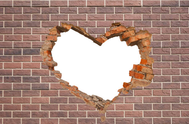 istock Heart shaped hole in old brick wall 1297241395
