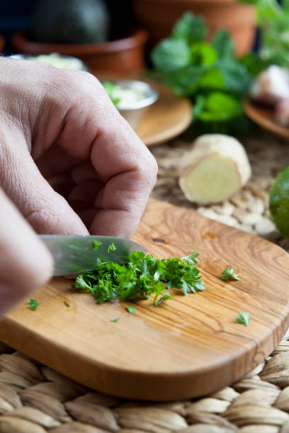 istock Chopping fresh cilantro herbs in the kitchen. 1297241781