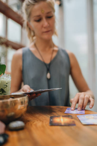 istock Woman is reading Tarot cards on a table in cafe 1297242346