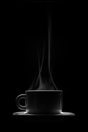 silhouette of the cup of coffee (or tea) with steam on a black background
