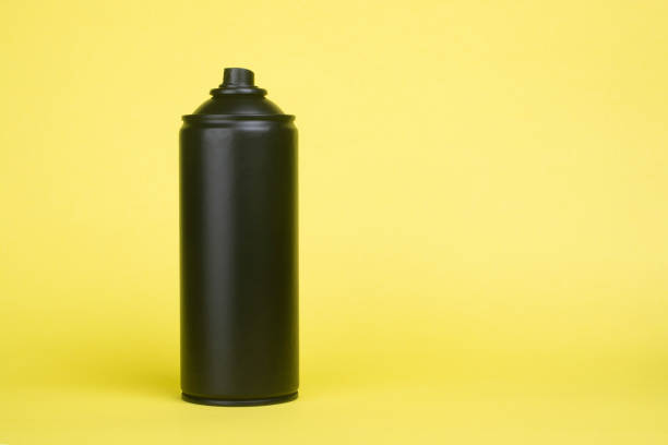 istock Black aerosol can on a yellow background. 1297245166