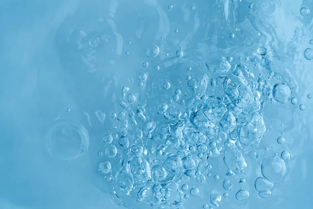 istock blue transparent clean drinking water abstract background. water surface with air bubbles background 1297246083
