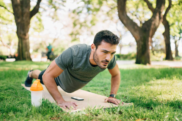 istock Man doing yoga in urban park 1297247137