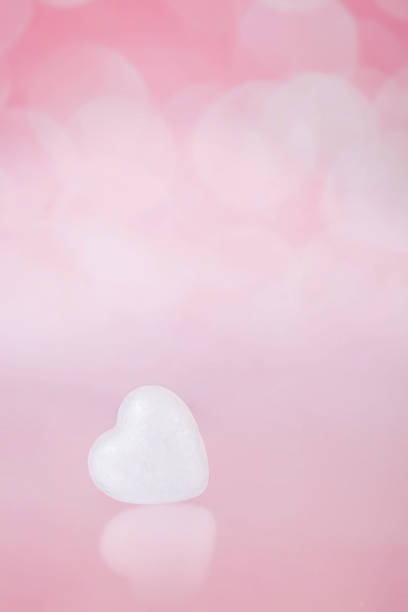 istock One little white heart on a pink with bohe background 1297247986