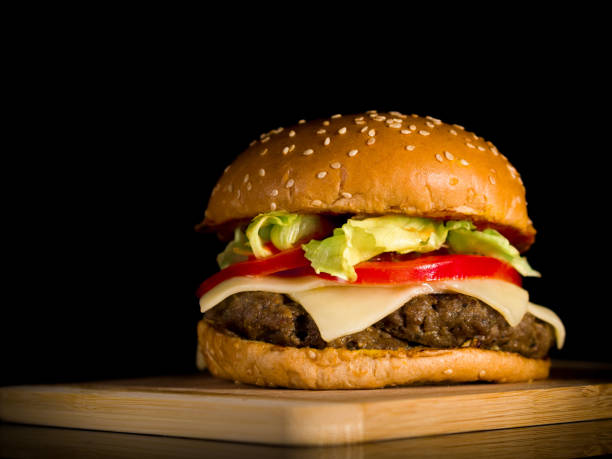istock Closeup of hamburger served on a wooden surface 1297248159