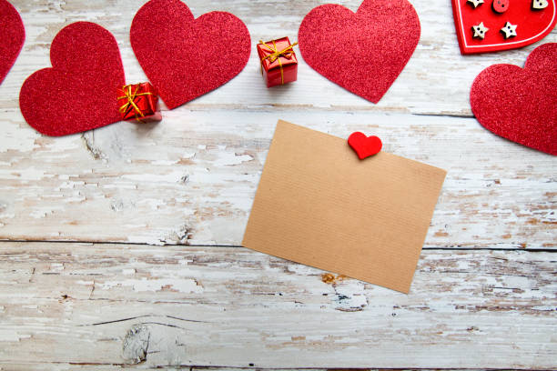 red valentine hearts with a card for text on a wooden background. valentines day concept. red valentine hearts with a card for text on a wooden background. valentines day concept. top view book heart shape valentines day copy space stock pictures, royalty-free photos & images