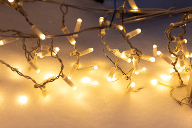 istock Yellow light garland on snow 1297250126