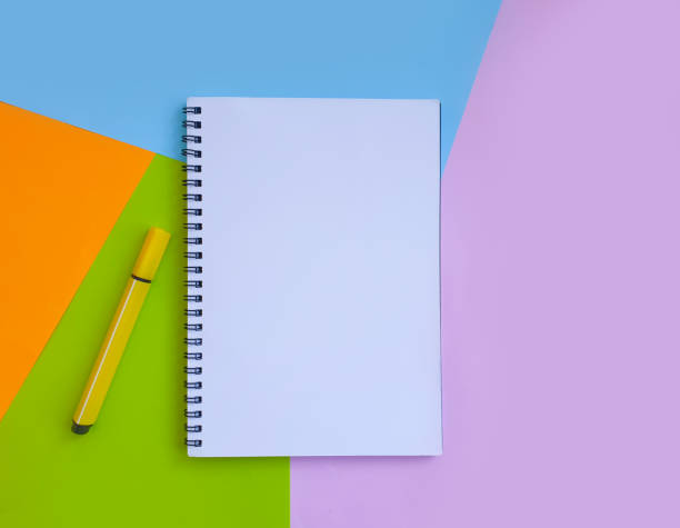 istock notebook, felt-tip pen on a background of colored paper 1297251494