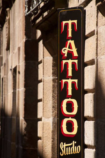 istock Tattoo studio sign in old town, stone facades. 1297252313