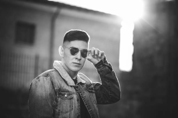 istock Young man with denim jacket and sunglasses. 1297253561