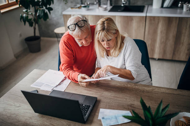 istock Senior couple doing finances together at home 1297253968
