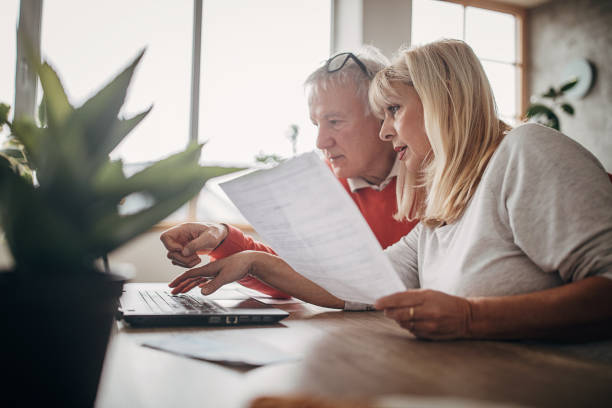 istock Senior couple doing finances together at home 1297254124