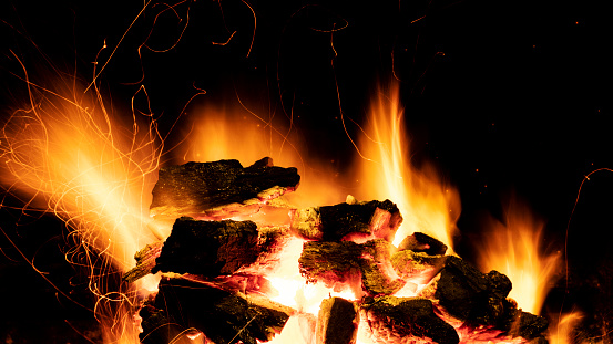 Charcoal fire burning.on a black background. Ideal for compositing with another image. The background can be removed with a blending mode like screen