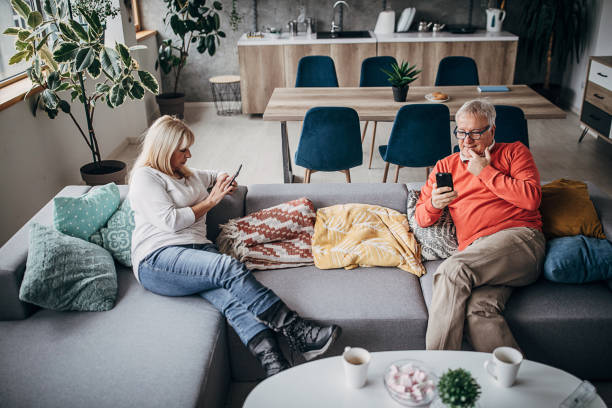 istock Senior couple relaxing on the sofa at home 1297257704