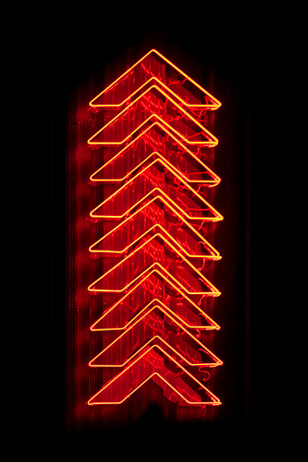 Set of red arrows neon light pointing up.