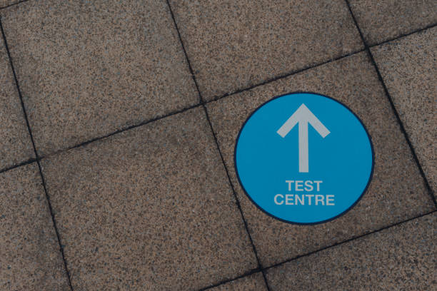 istock Arrow sign to Coronavirus Test Centre on a pavement in Birmingham, UK. 1297258927