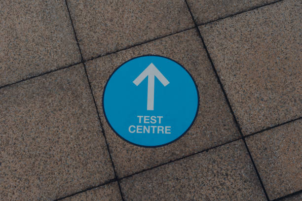 istock Arrow sign to Coronavirus Test Centre on a pavement in Birmingham, UK. 1297258930
